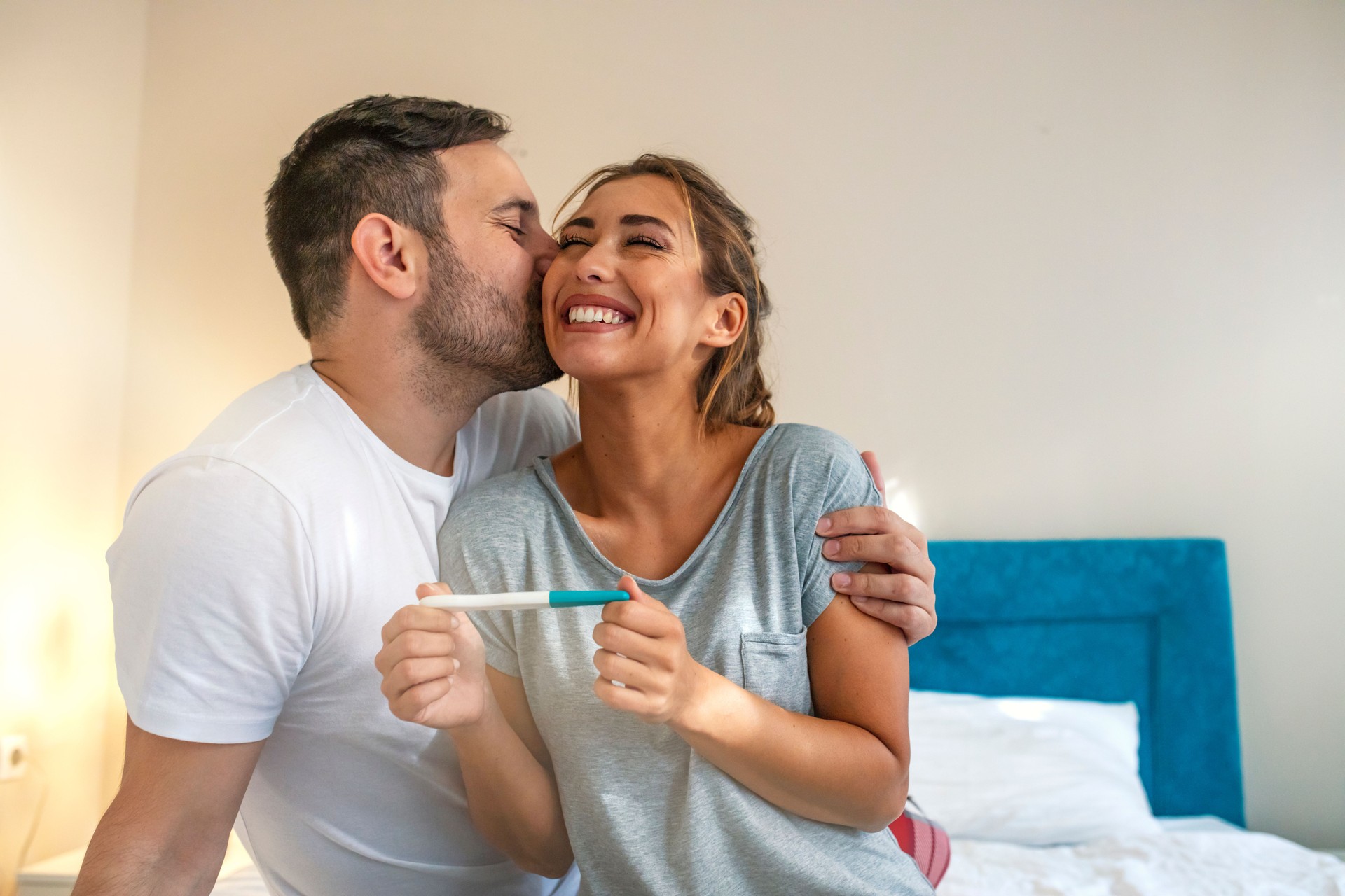 Young couple is happy because of positive pregnancy test.